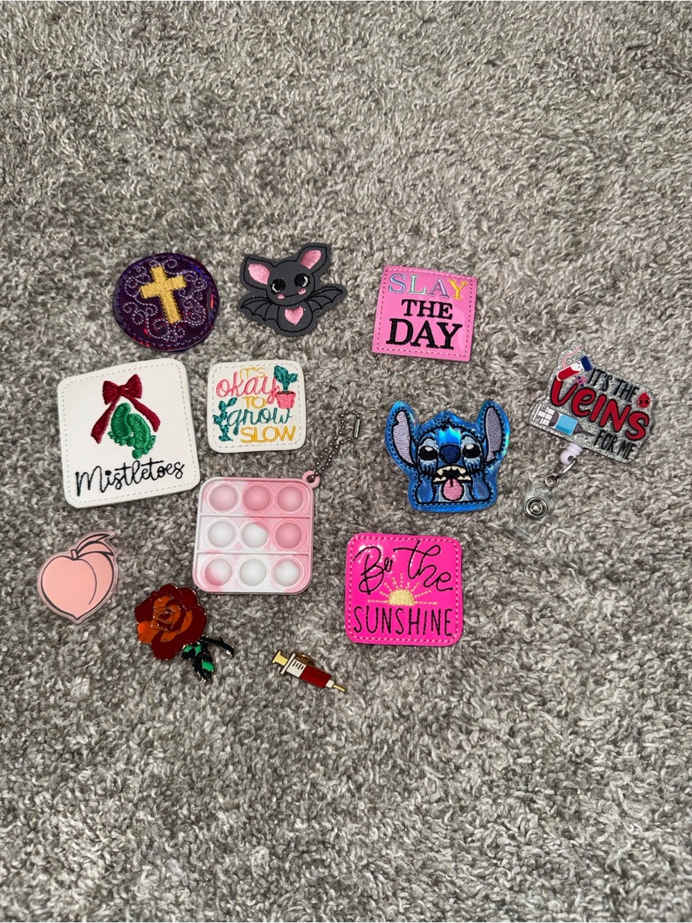 Assortment of Nurse Badge Reels & Patches, Pins, & Pop-It Bubble Keychain